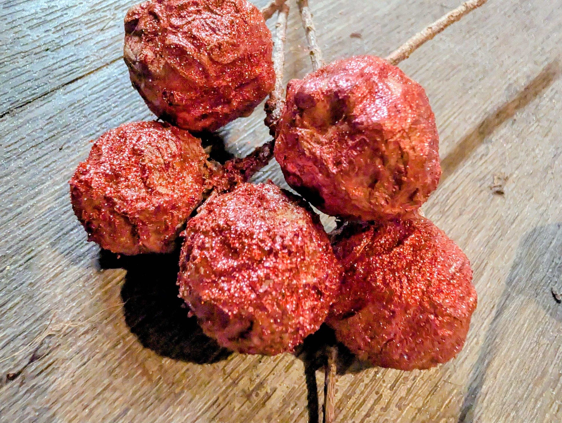 Close-up of metallic wine powdered  bald cypress on a wooden surface